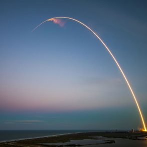 A rocket launching in a blue sky
