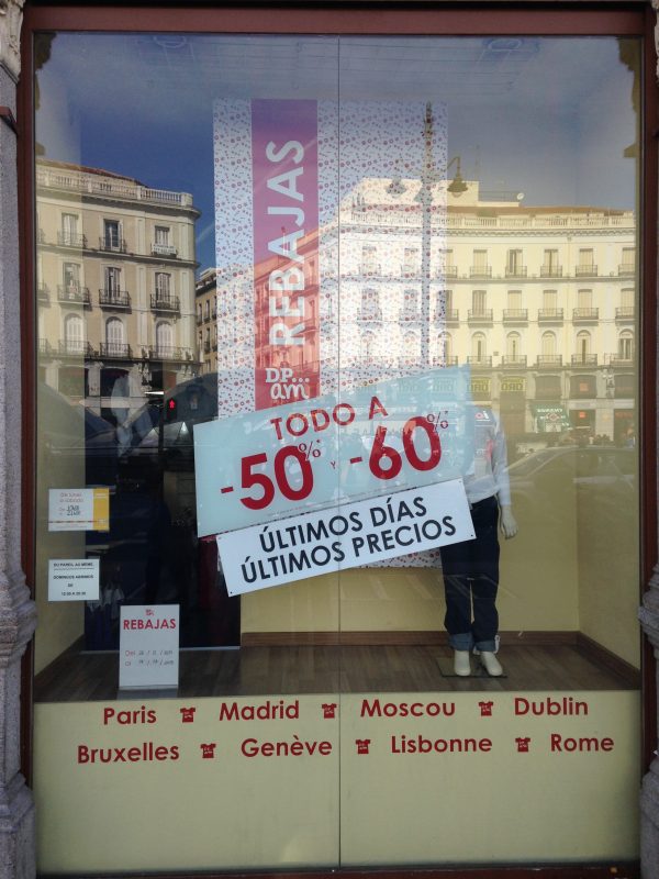 A window display with rebajas advertisements