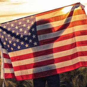 Silhouette of girl holding U.S. flag