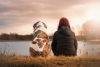 Isolated dog and girl staring across lake