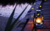 Hurricane lamp at twilight next to river