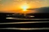Sunset over winding river on prairie