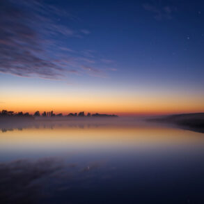 Twilight with stars over pond