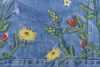 Flowers embroidered onto denim