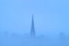 Church steeple in blue fog