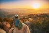 Woman overlooking valley at sunset