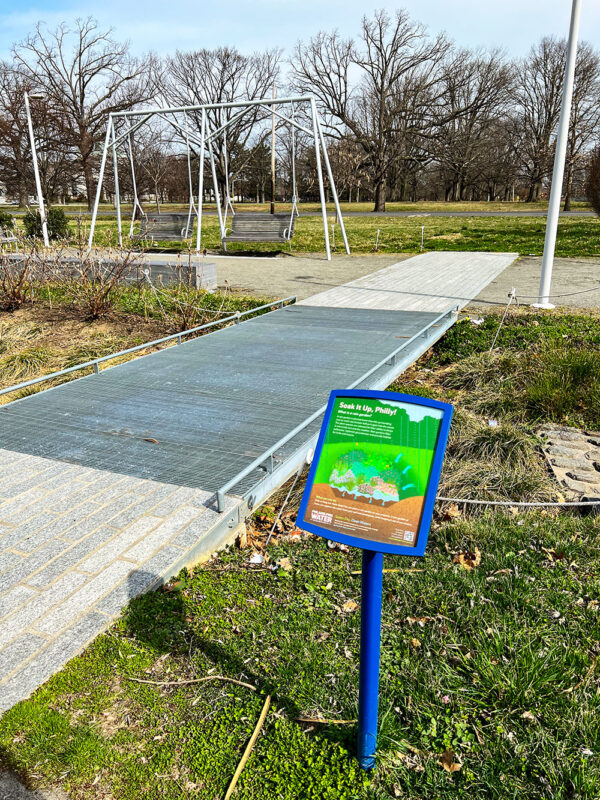 Centennial Commons sign and swinging benches
