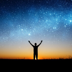 Man silhouetted against starry sky