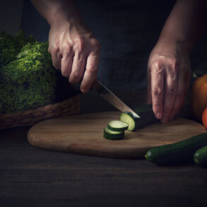 Hands cutting vegetables