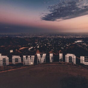 Hollywood sign from behind with view of Los Angeles at twilight