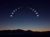 Moon phases at dusk over silhouette of mountains